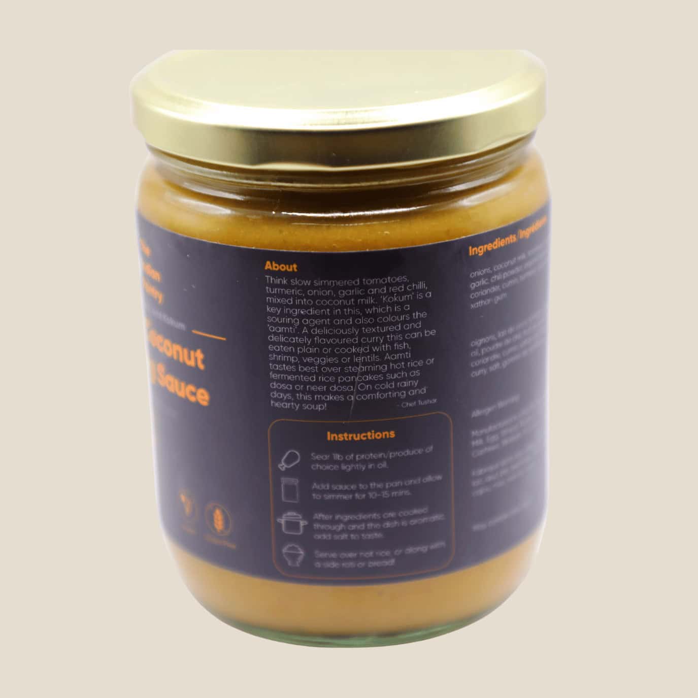A jar of Indian curry sauce containing turmeric, onion, garlic, chili, and coconut milk, perfect for making flavorful Indian dishes with ingredients essential for authentic taste.