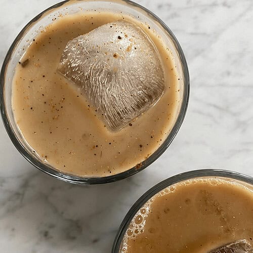 Delicious Indian-style milk tea with ice and spices, served chilled, perfect for refreshment and authentic taste of Indian beverages.